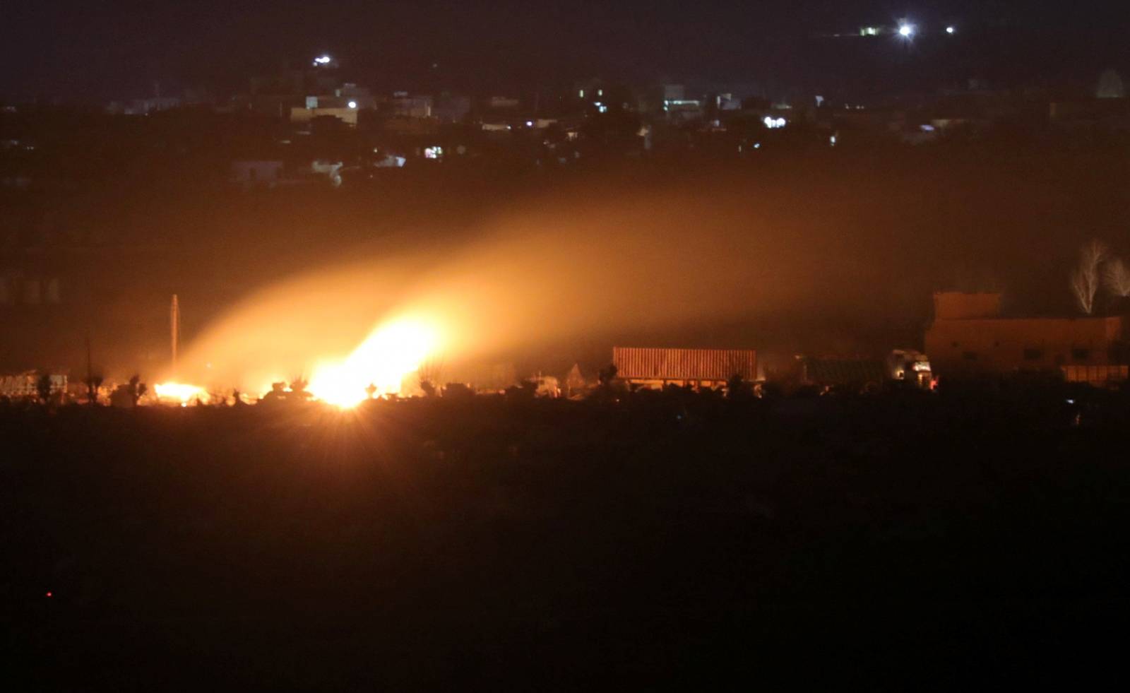 Fire from fighting is seen in Baghouz, Deir Al Zor province