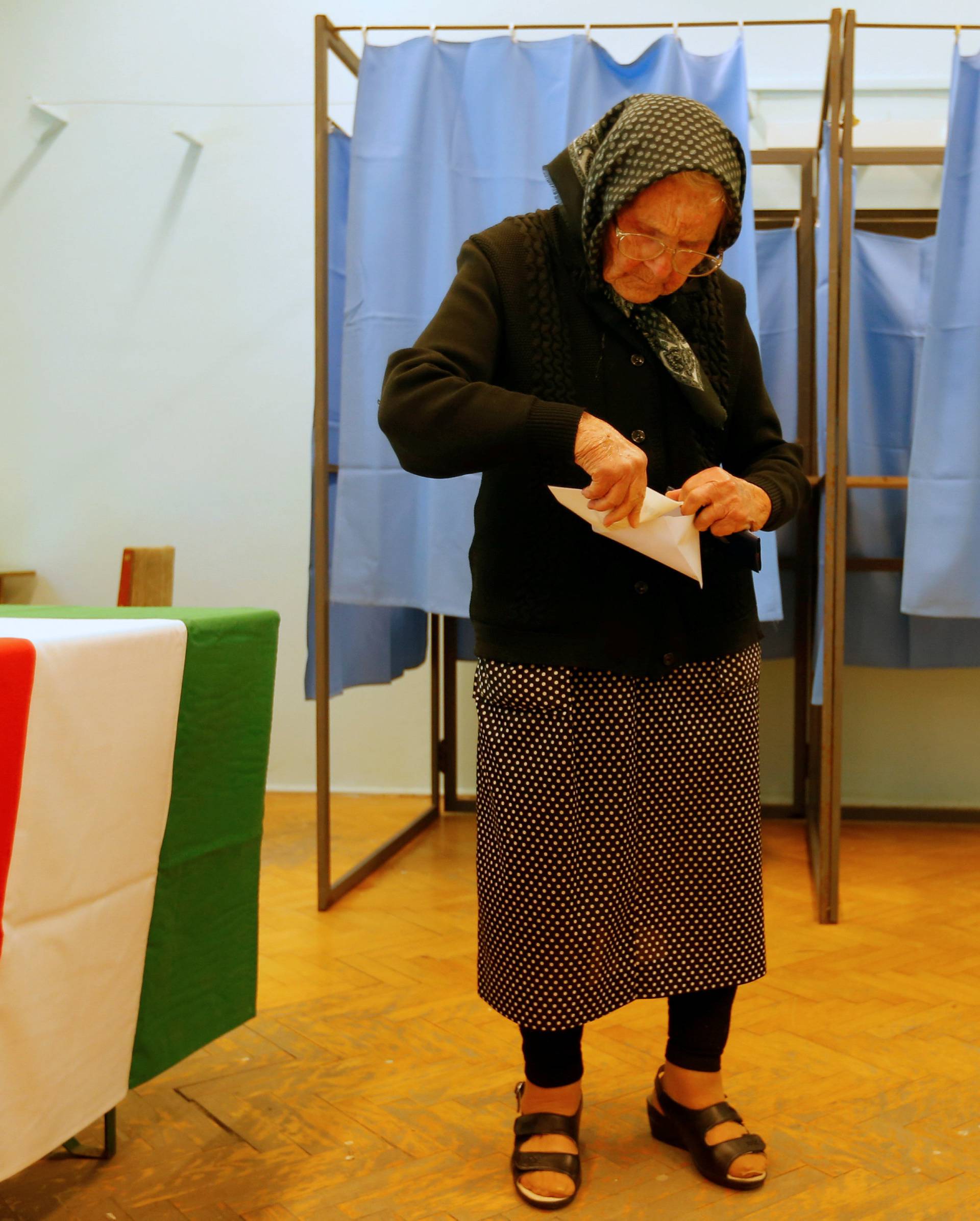 A Hungarian woman votes in a referendum on the European Union's migrant quotas in village of Roszke near the Serbian border