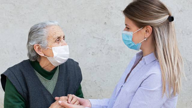 Portrait,Of,Friendly,Caregiver,Posing,With,Elderly,Ill,Woman,Wearing