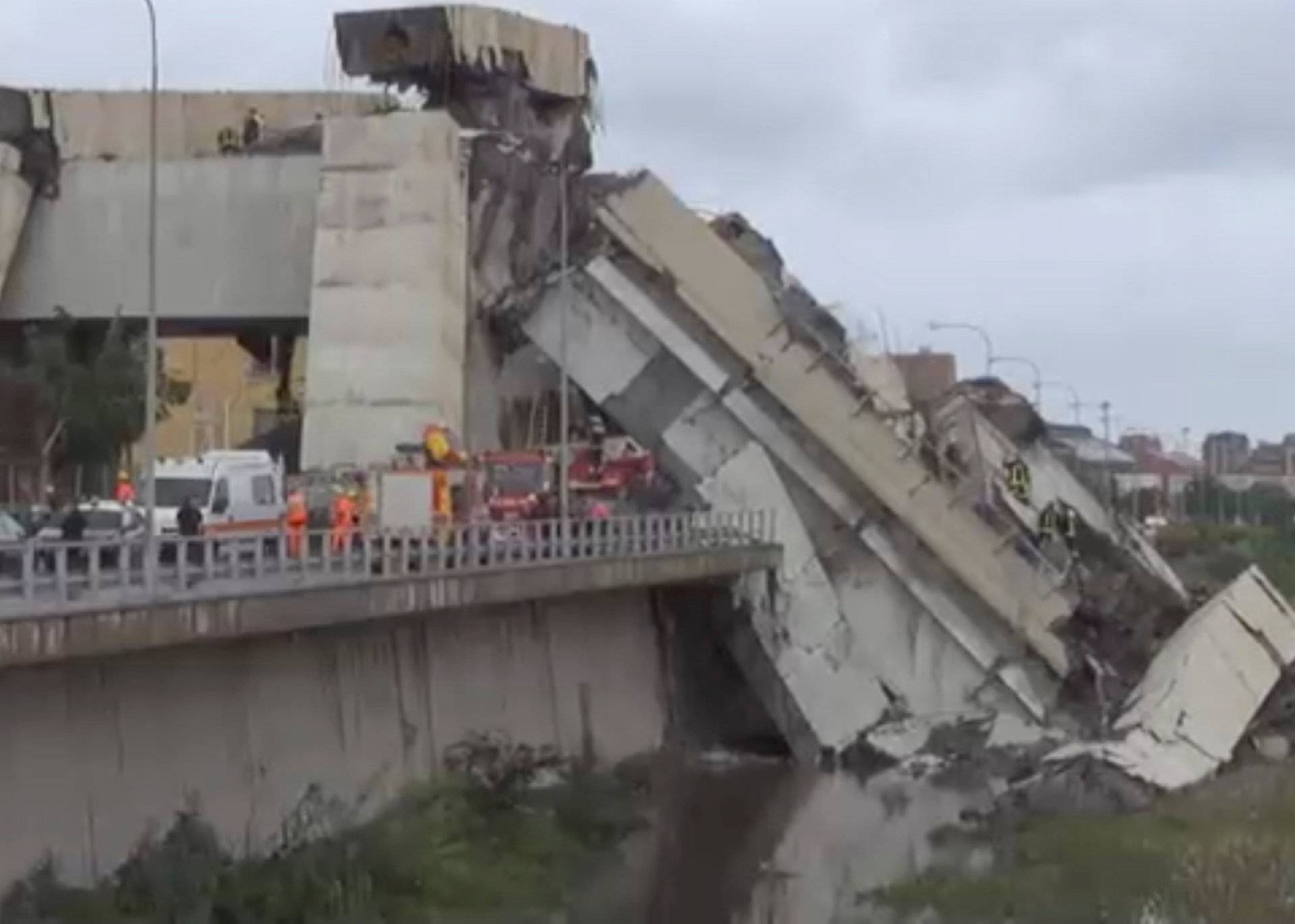 Rescue workers are seen at the collapsed Morandi Bridge in the Italian port city of Genoa