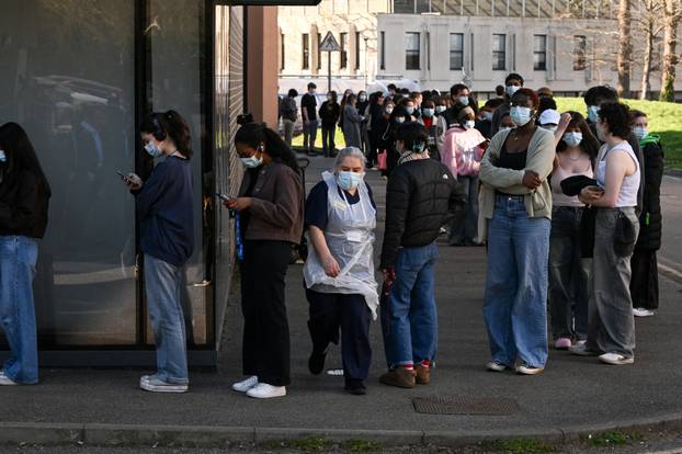 People queue to receive vaccinations at the Sports centre on the University of Kent campus, following an outbreak of meningitis cases in Kent