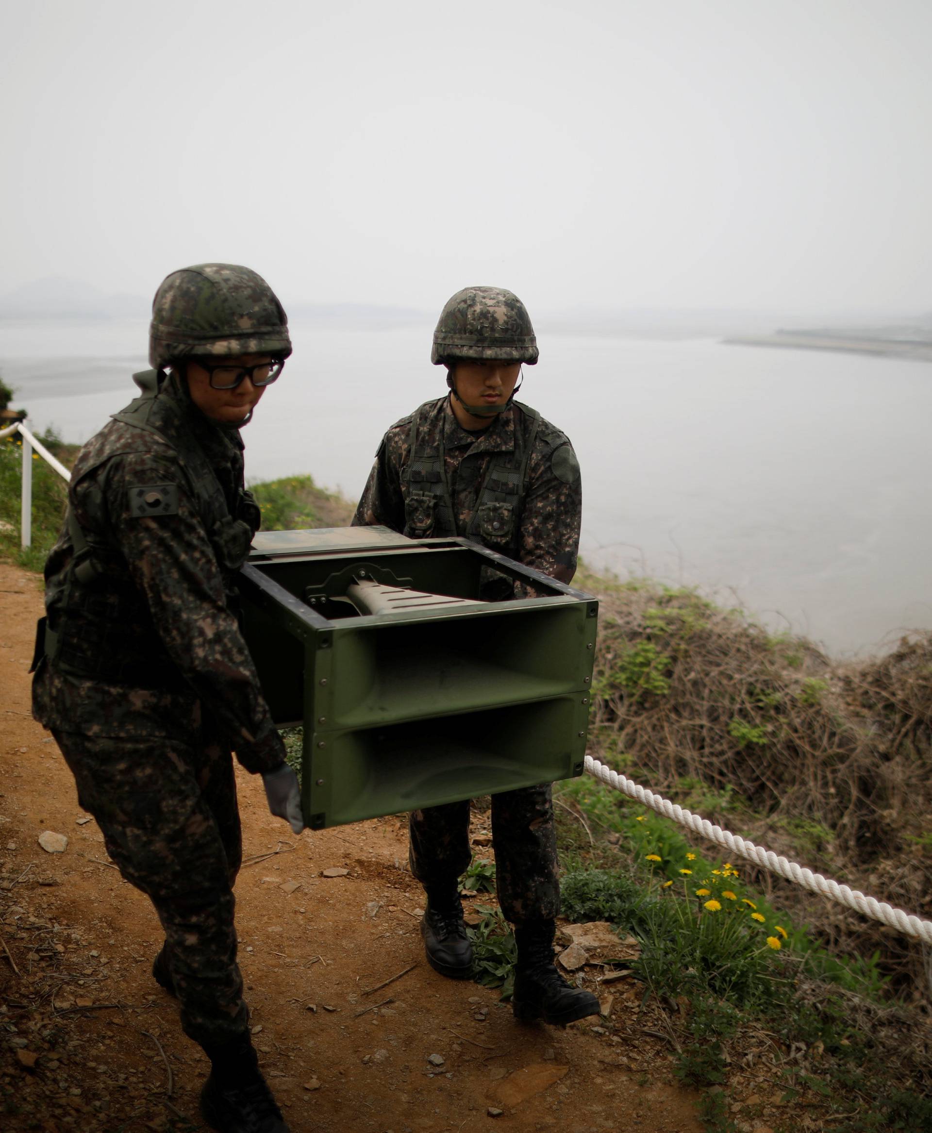 South Korean soldiers move loudspeakers that were set up for propaganda broadcasts near the demilitarized zone separating the two Koreas in Paju