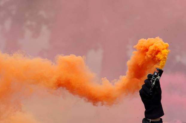 Protester holds a smoke safety flare during the May Day labour union march in Paris