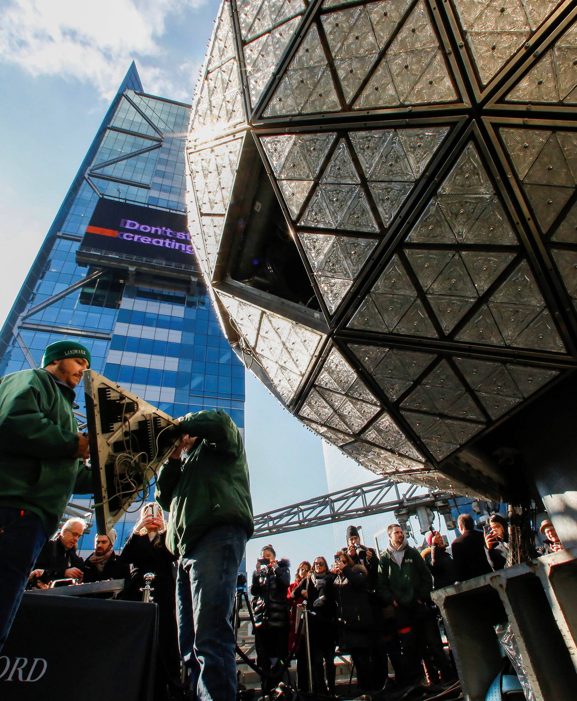 Workers get ready to install Waterford Crystal triangles on the Times Square New Year's Eve Ball on the roof of One Times Square in the Manhattan borough of New York