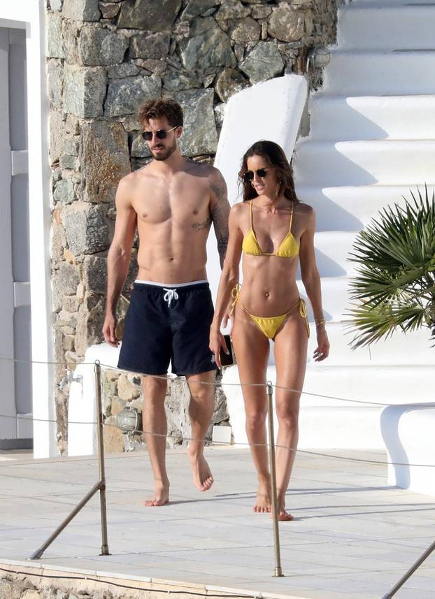 Izabel Goulart showcases off her toned frame in a yellow bikini as she packs on the PDA with footballer fiancÃ© Kevin Trapp in Mykonos