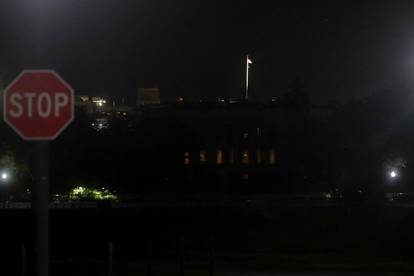 A U.S. flag flies at over the darkened White House during protests against the death in Minneapolis police custody of George Floyd, in Washington