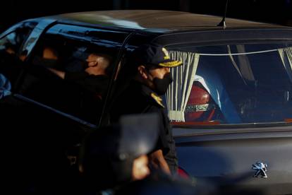 The car carrying the casket of soccer legend Diego Maradona arrives at the cemetery in Buenos Aires, Argentina
