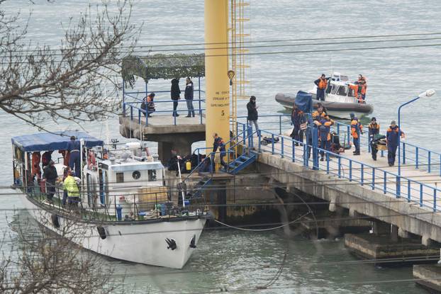 Russian Emergencies Ministry members work at quay of Black Sea near crash site of Russian military Tu-154 plane in Khosta
