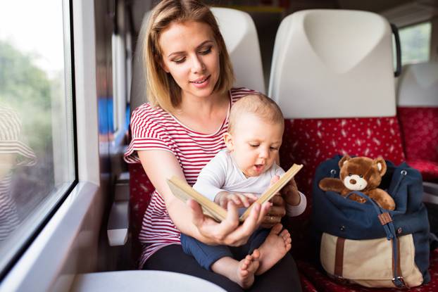 Young,Mother,Travelling,With,Baby,By,Train.