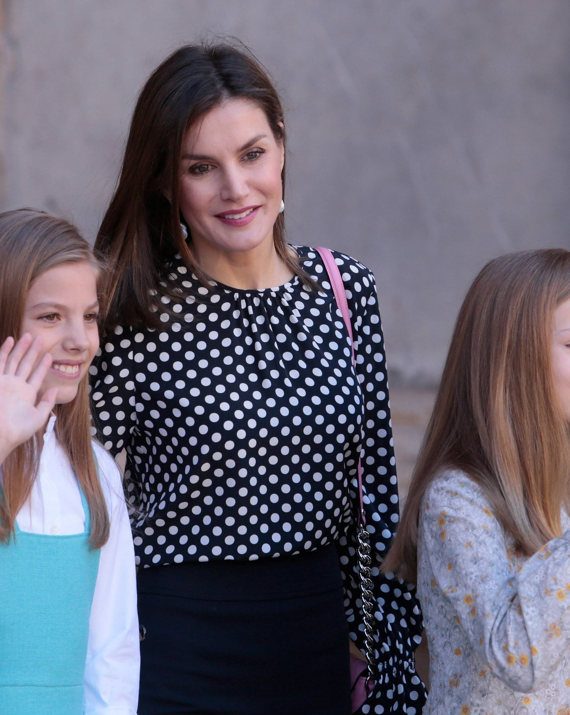 Spanish Royal Family Queen Letizia and daughters Infantas Leonor and Sofia gesture after attending an Easter Sunday mass at Palma de Mallorca's Cathedral on the Spanish island of Mallorca