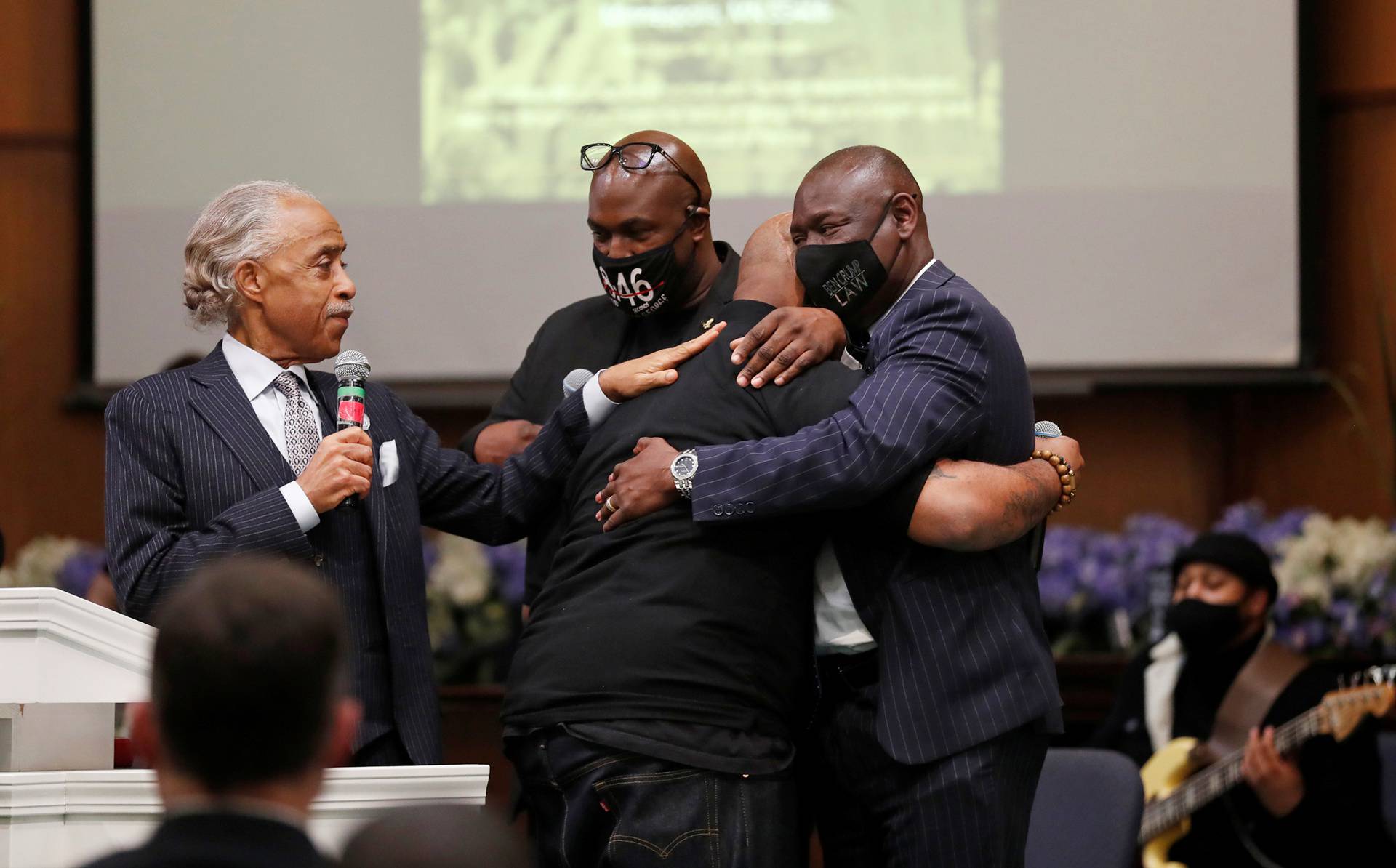 Terrence, brother of George Floyd, is comforted by Rev. Al Sharpton, his brother Philonise, and attorney Ben Crump during a prayer vigil in Minneapolis