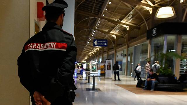 A police officer stands guard at a shopping center where several people were injured, including Monza's football player Pablo Mari, after a stabbing incident in Assago