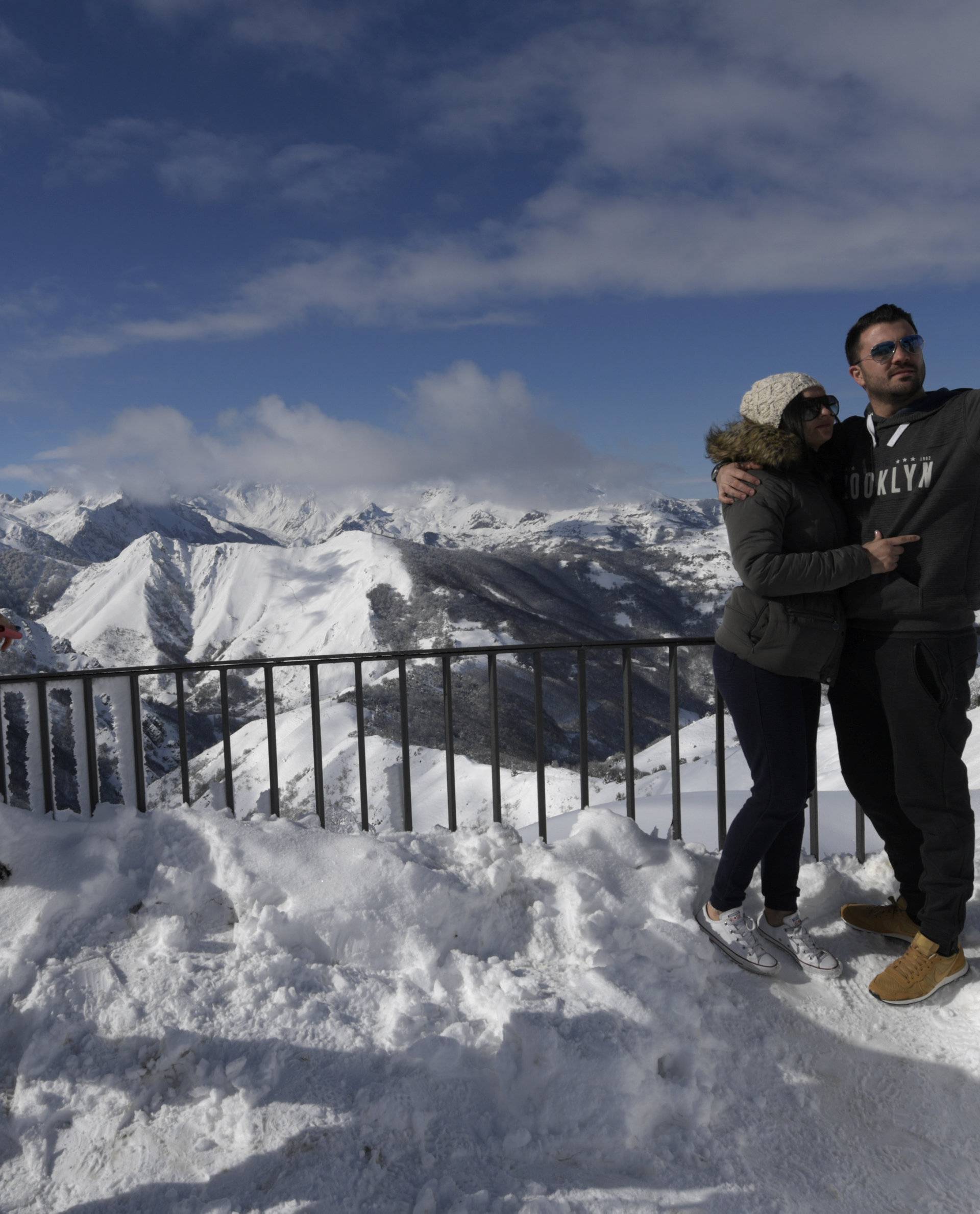 A couple makes a self-portrait on top of the ountain pass of Pajares