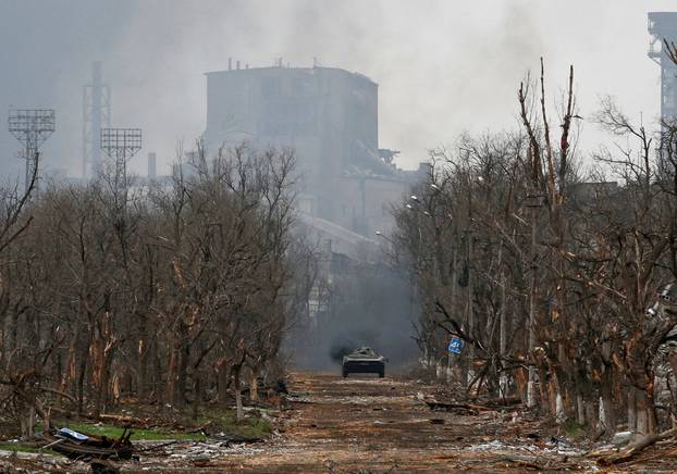 FILE PHOTO: An armoured vehicle of pro-Russian troops drivers along a street during fighting near Azovstal plant in Mariupol