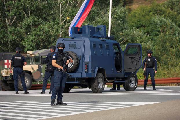Kosovo police and U.S. and EU troops stand by after one police officer was killed, another hurt in Kosovo gunfire, in Josevik