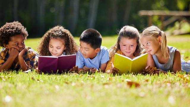 Children,,Books,And,Lying,In,Park,With,Friends,,Learning,Or