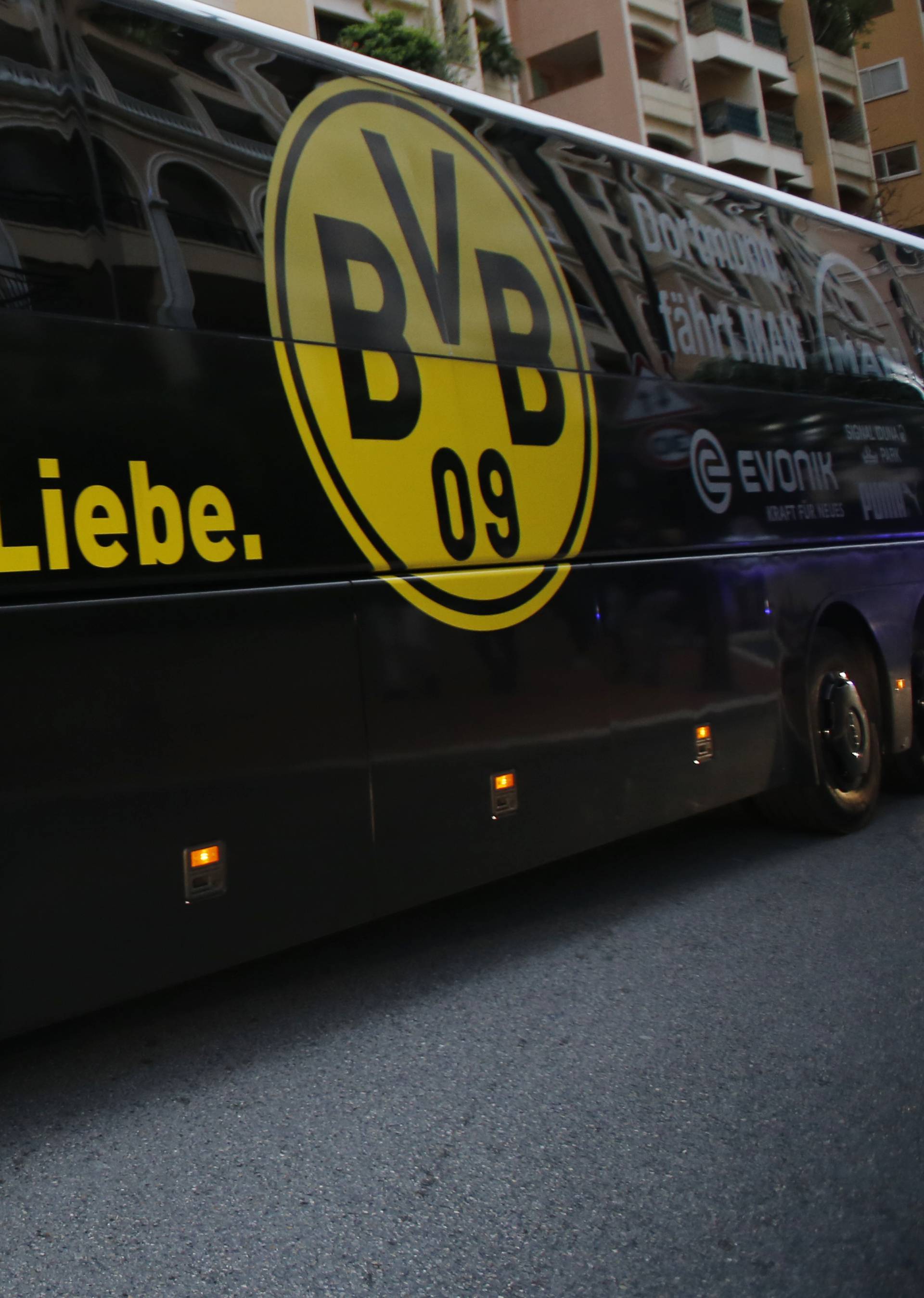 Police look on as the Borussia Dortmund team bus arrives before the match