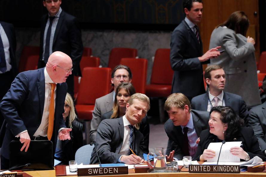 Russian Ambassador to the U.N., Nebenzya speaks with Britain's Ambassador to the U.N., Pierce, after a meeting convened to discuss an incident in Salisbury, during a meeting of the U.N. Security Council in New York