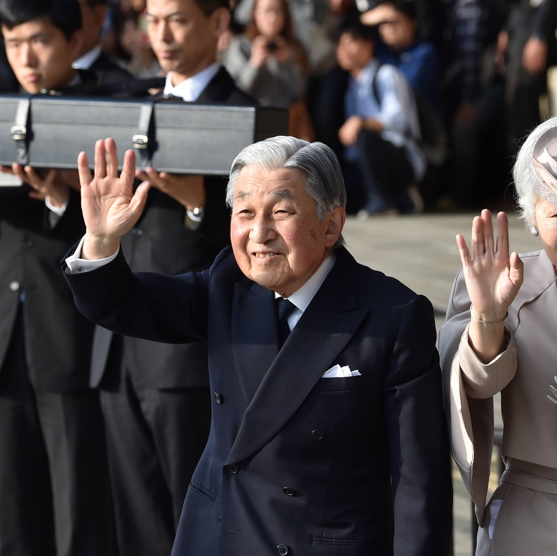 Japan's Emperor Akihito, accompanied by Empress Michiko, waves to well-wishers before leaving Ujiyamada Station after their visit to Ise Jingu shrine in Ise, Japan