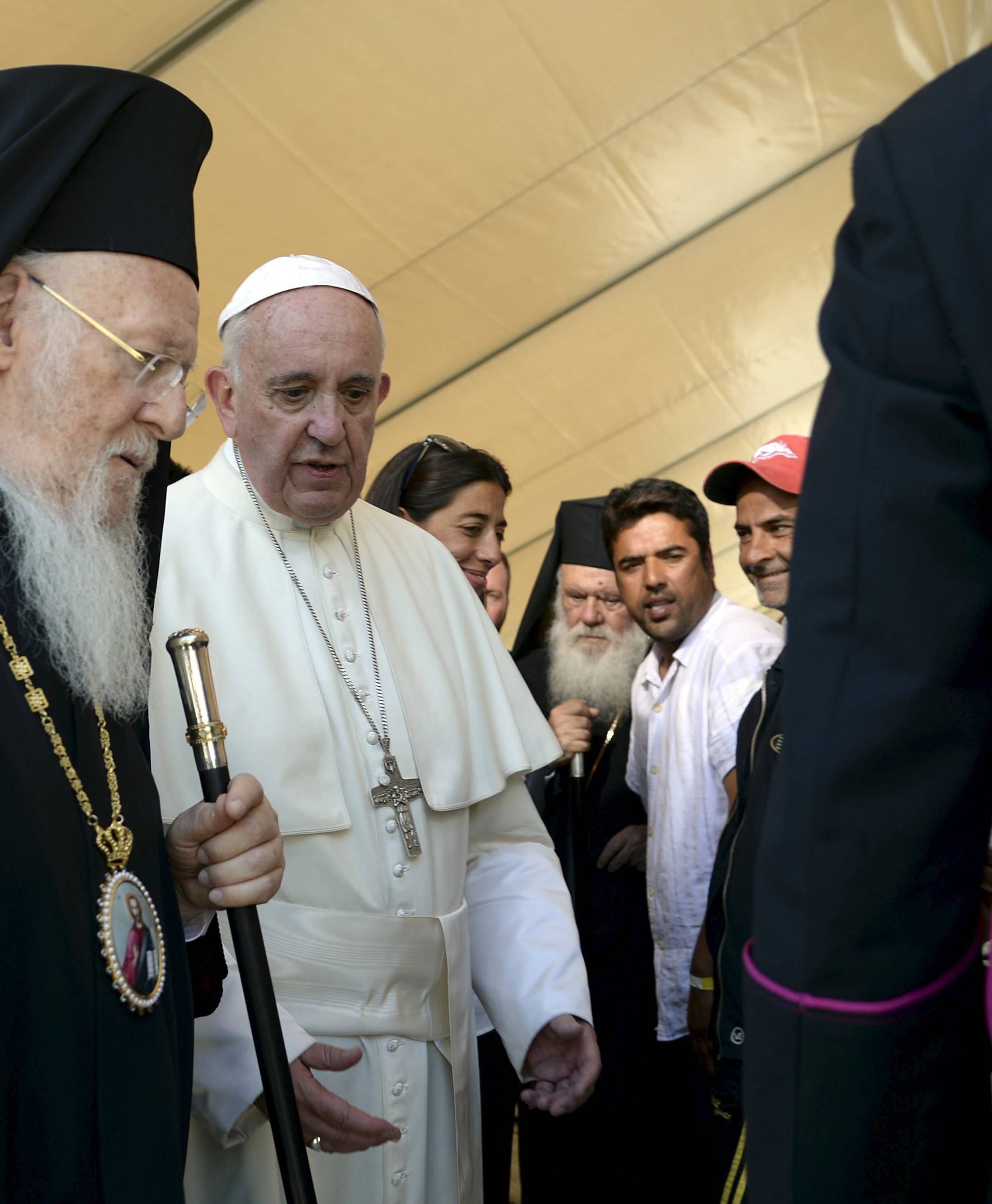 Pope Francis and Patriarch Bartholomew I greet migrants and refugees at the Moria refugee camp near the port of Mytilene, on the Greek island of Lesbos 