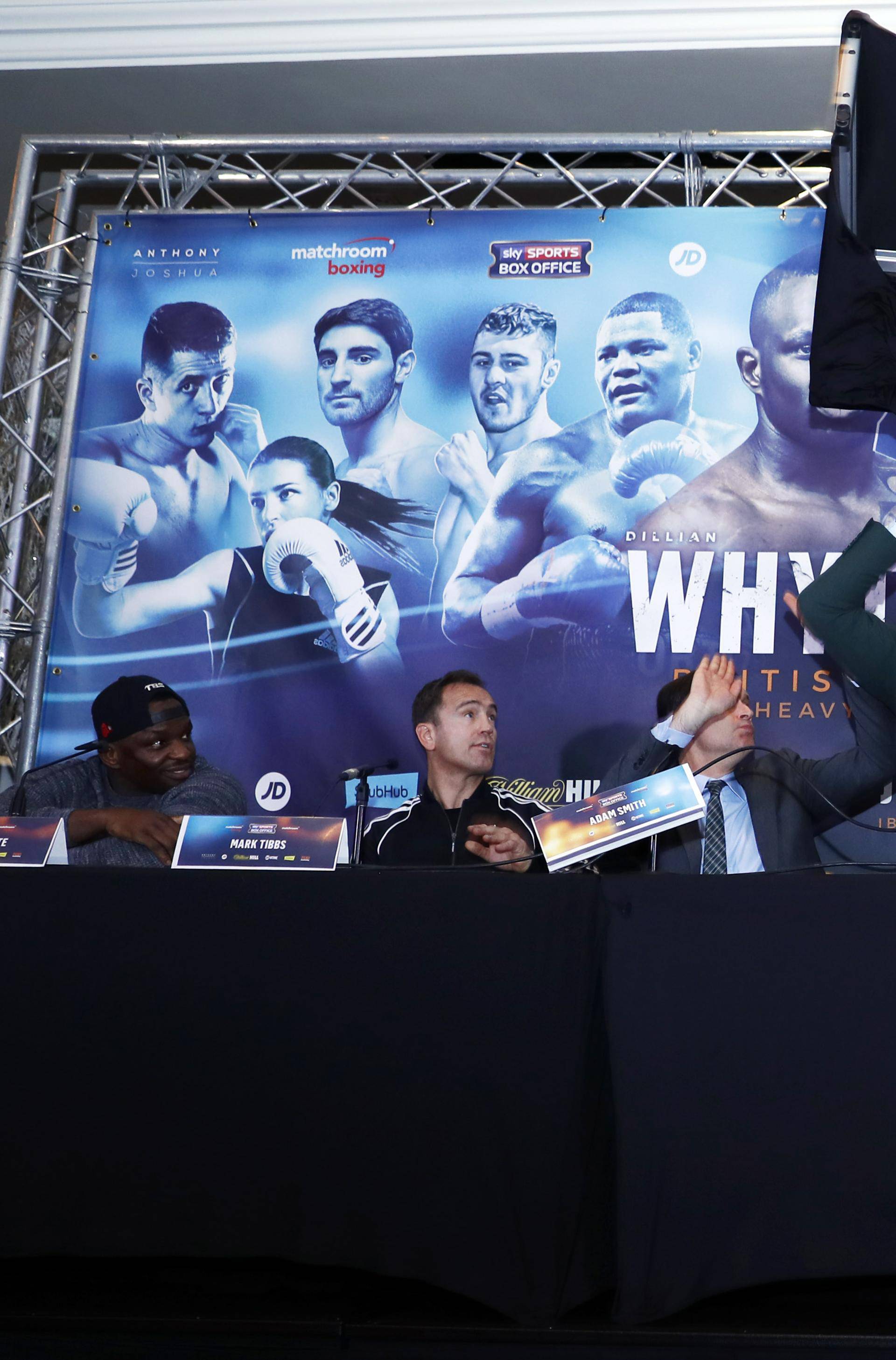 Dillian Whyte, trainer Mark Tibbs, Sky Sports' Adam Smith, promoter Eddie Hearn and promoter Kalle Sauerland look on as Dereck Chisora throws a table during the press conference
