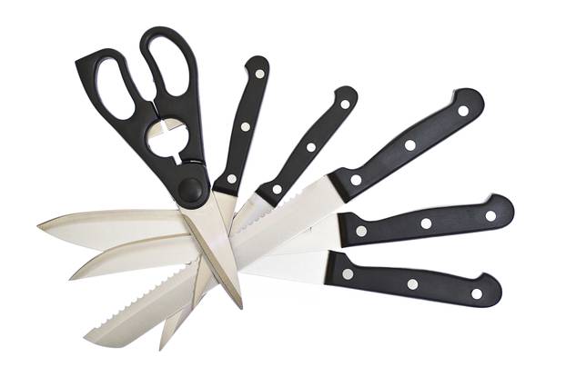 The collection of kitchen knives and scissors on white backgroun