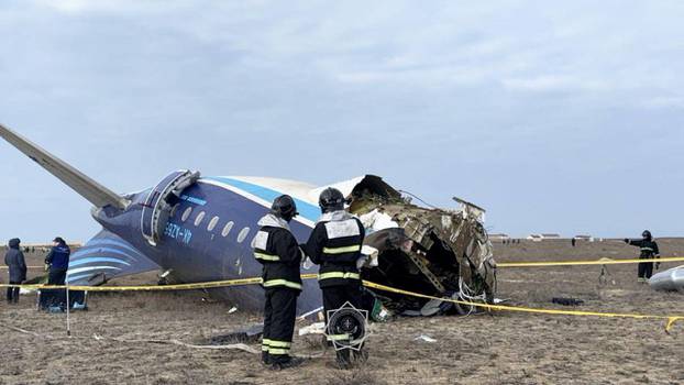 Emergency specialists work at the crash site of a passenger plane near Aktau