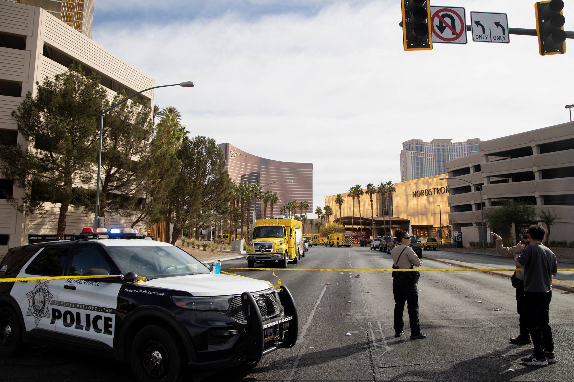 Firefighters work at the Tesla Cybertruck which burned at the entrance of Trump Tower in Las Vegas