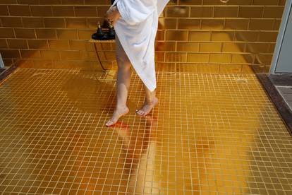 A woman poses for a photo at the gold plated infinity pool of the newly-inaugurated Dolce Hanoi Golden Lake luxury hotel, after the government eased a nationwide lockdown following the global outbreak of the coronavirus disease (COVID-19), in Hanoi