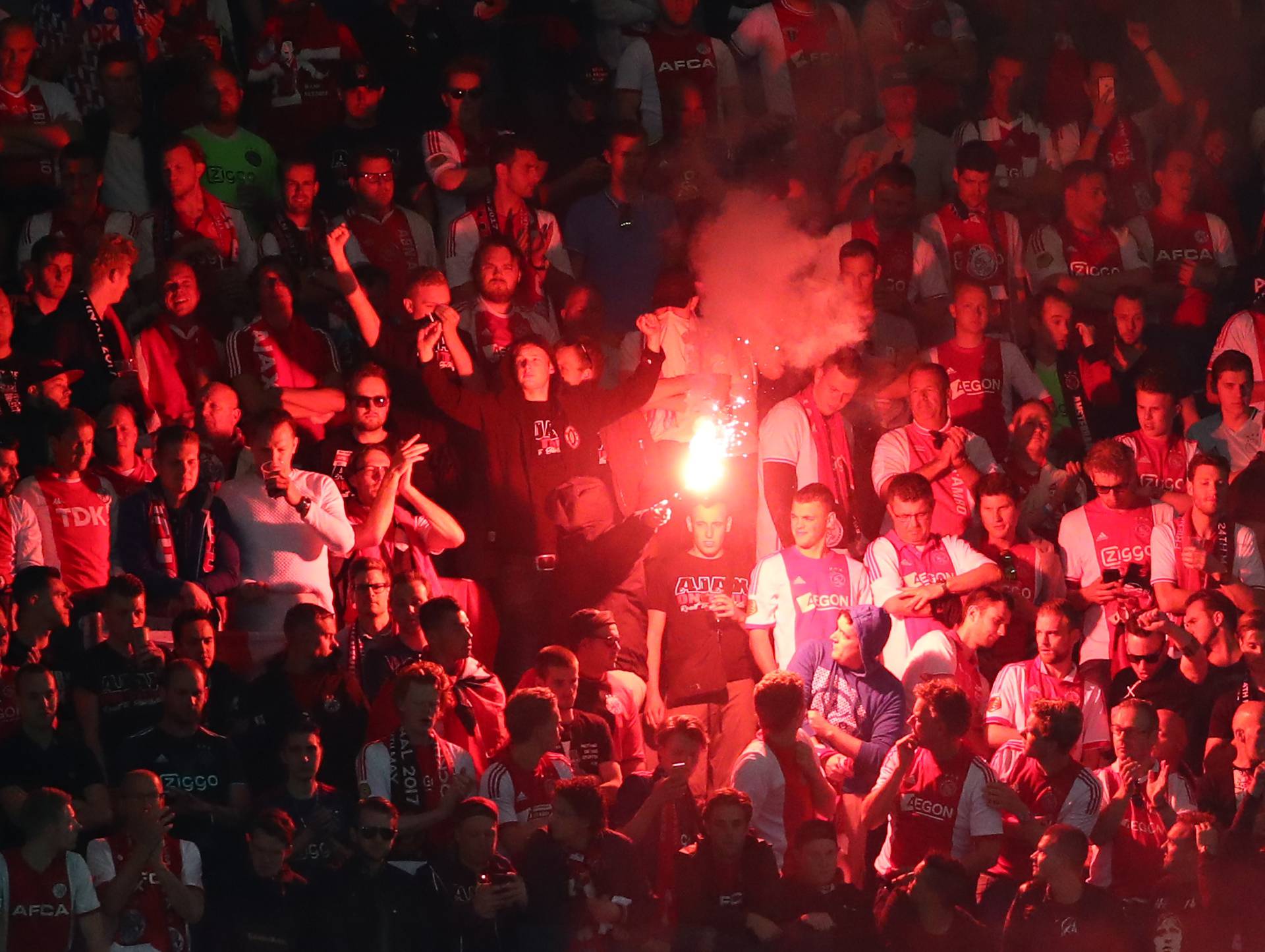 Ajax fan with a flare during the game