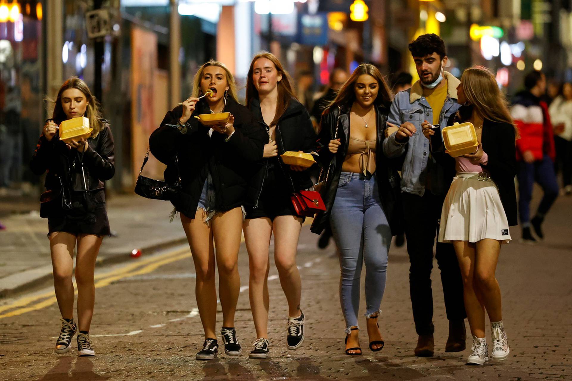 People walk and gather outside bars the night before a local lockdown amidst the spread of the coronavirus disease (COVID-19) in Liverpool