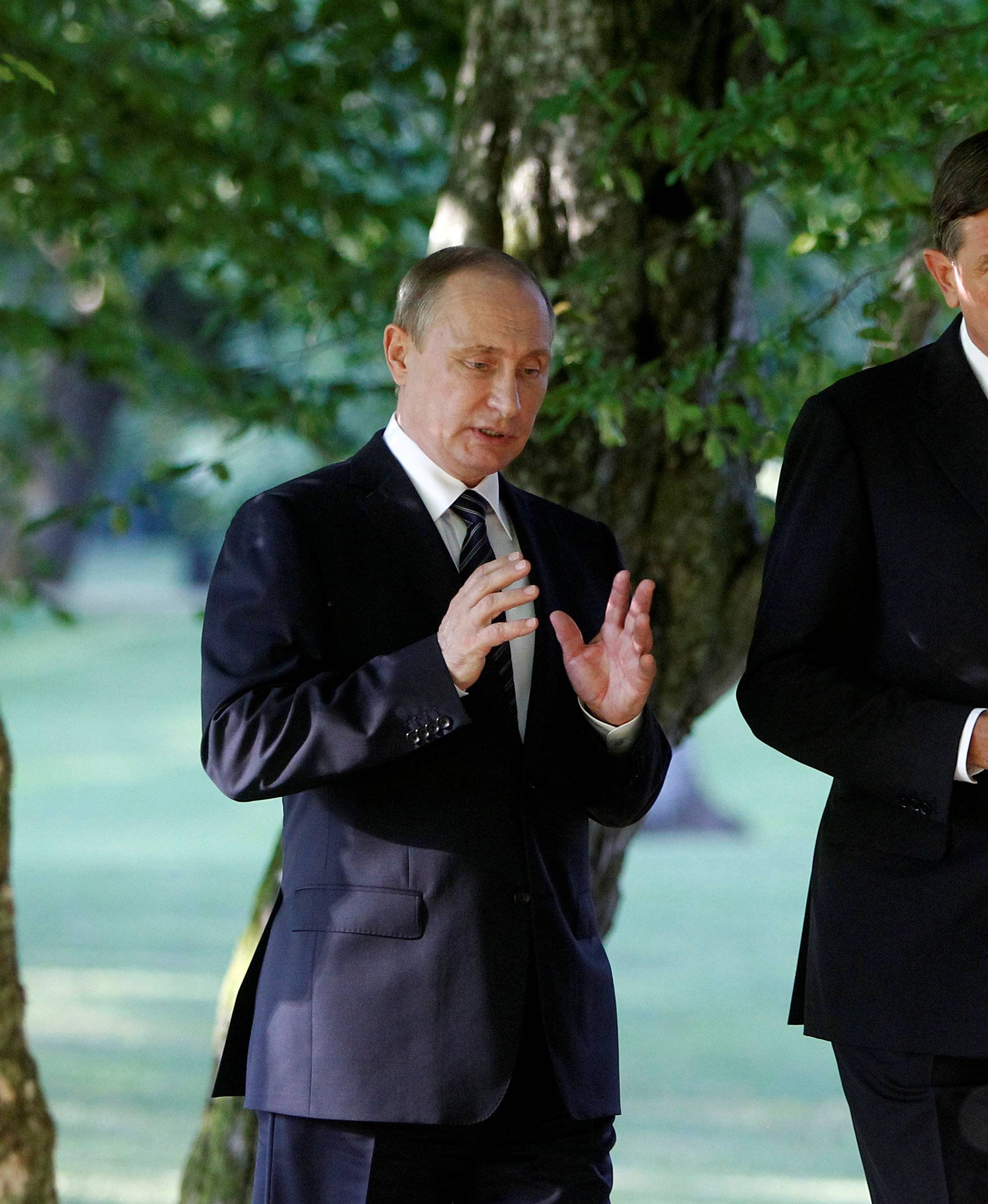Russian President Vladimir Putin and Slovenian President Borut Pahor (R) speak after visiting the memorial for all fallen Russian soldiers in Slovenia during World War One and Two, in Ljubljana
