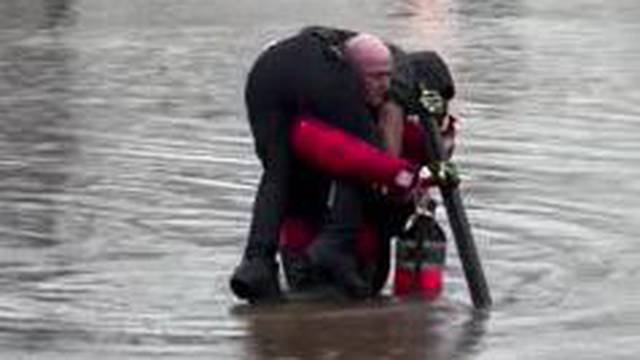 Policeman rescues motorist from flooded car in New Jersey