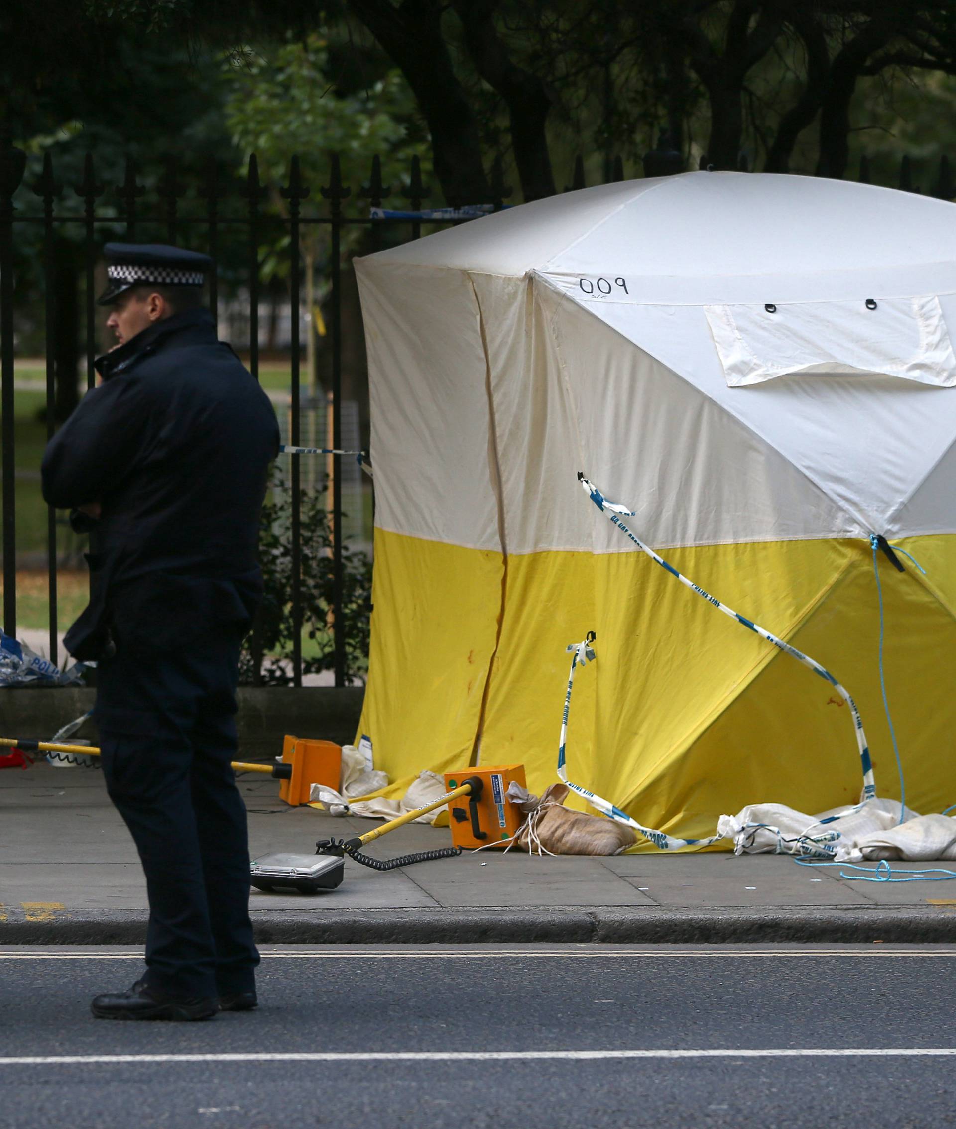 Police officers stand near a forensics tent after a knife attack in Russell Square in London