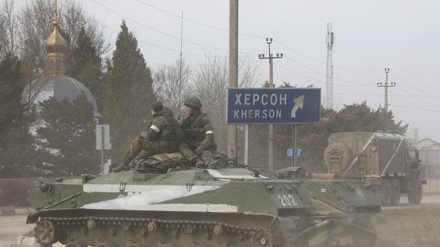 An armoured vehicle drives along a street in Armyansk