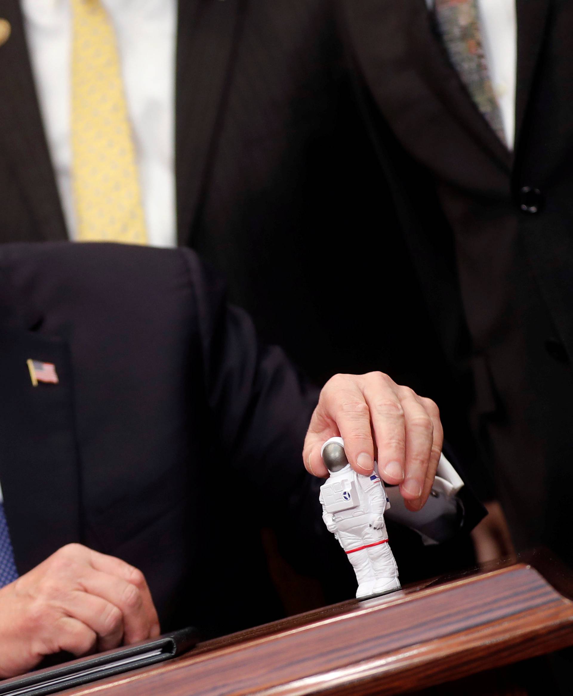U.S. President Donald Trump holds a space astronaut toy as he participates in a signing ceremony for Space Policy Directive at the White House in Washington D.C.
