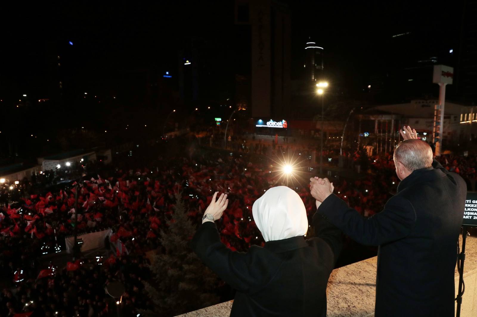 Turkish President Tayyip Erdogan and his wife Emine Erdogan greet AK Party supporters in Ankara