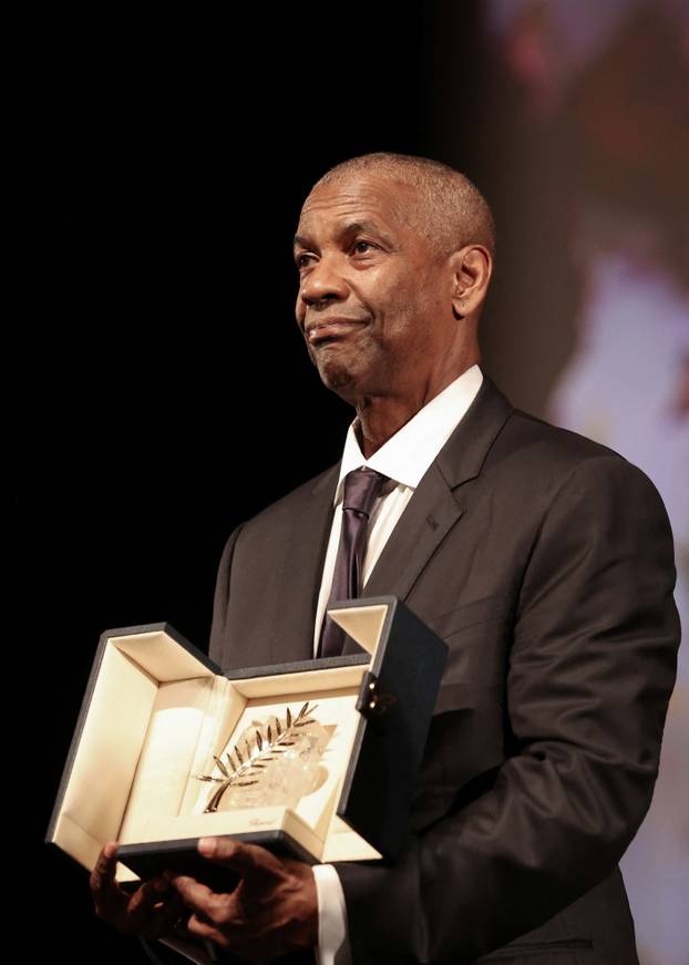Denzel Washington receives the Honorary Palme d'Or from director Spike Lee, ahead of the screening of the film "Highest 2 Lowest", at the 78th edition of the Cannes Film Festival in Cannes