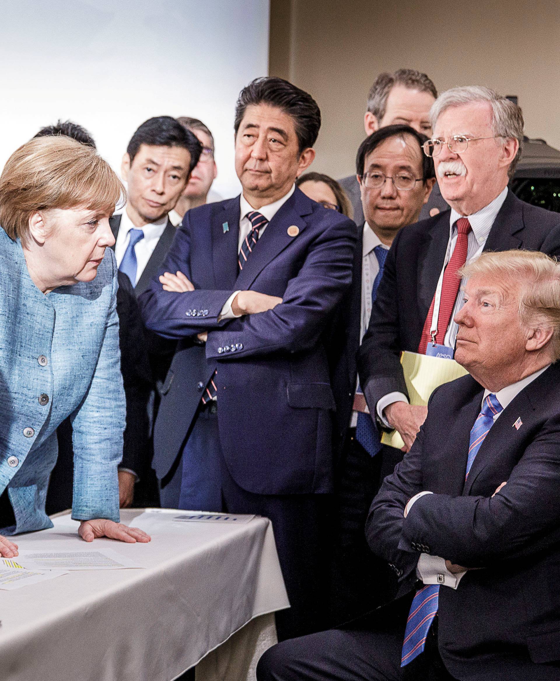 German Chancellor Merkel speaks to U.S. President Trump during the second day of the G7 meeting in Charlevoix city of La Malbaie, Quebec