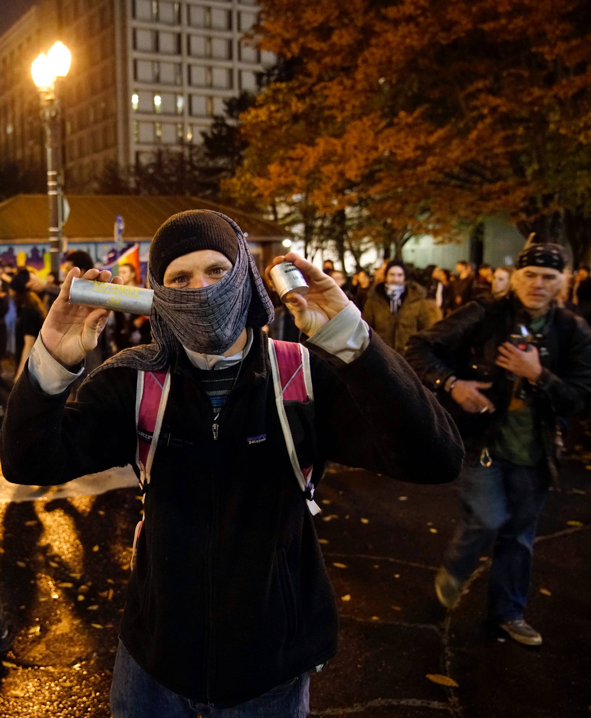 A demonstrator holds up cartridges during a protest against the election of Republican Donald Trump as President of the United States in Portland, Oregon