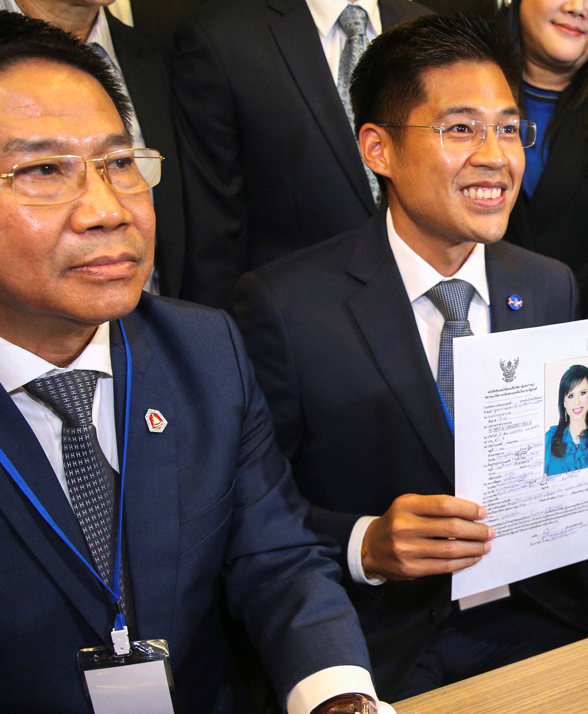 Thai Raksa Chart party leader Preechapol Pongpanich, holds up application of candidate for Prime Minister, Thailand's Princess Ubolratana Rajakanya Sirivadhana Varnavadi, at the election commission office in Bangkok