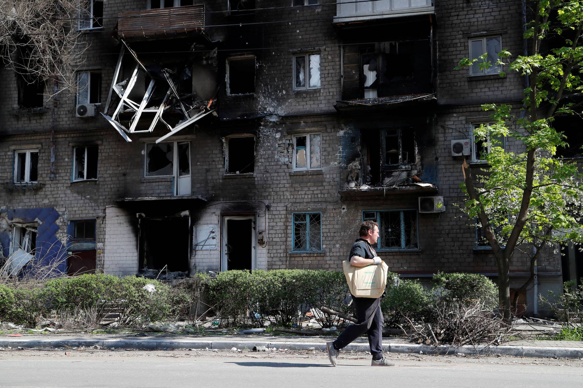 A view shows a damaged residential building in Mariupol