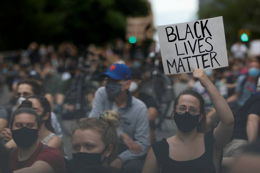 FILE PHOTO: People hold a vigil near Gracie Mansion as protests against the death in Minneapolis police custody of George Floyd continue, in New York City