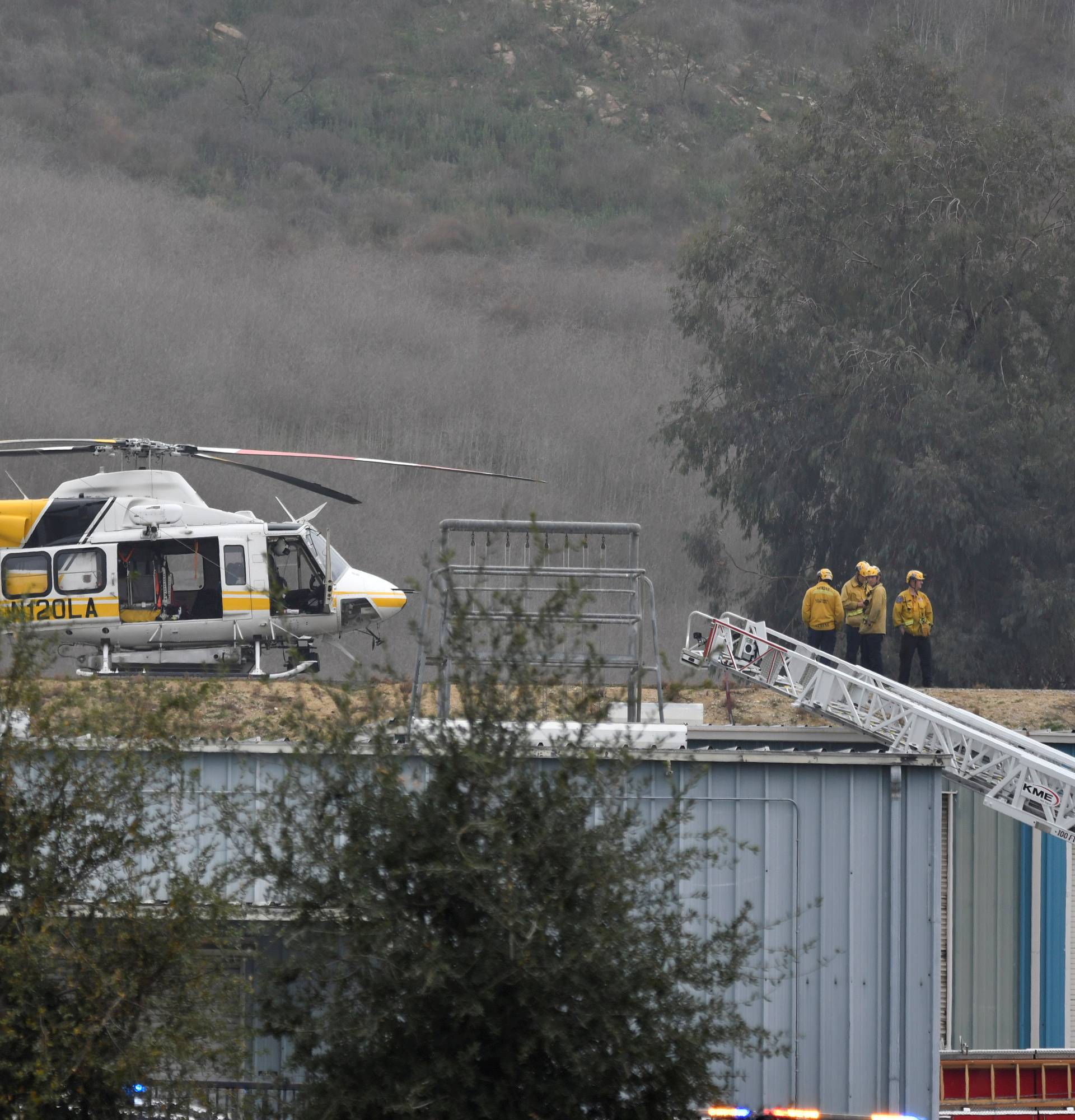 LA county firefighters work at the scene of a helicopter crash that reportedly killed Kobe Bryant in Calabasas