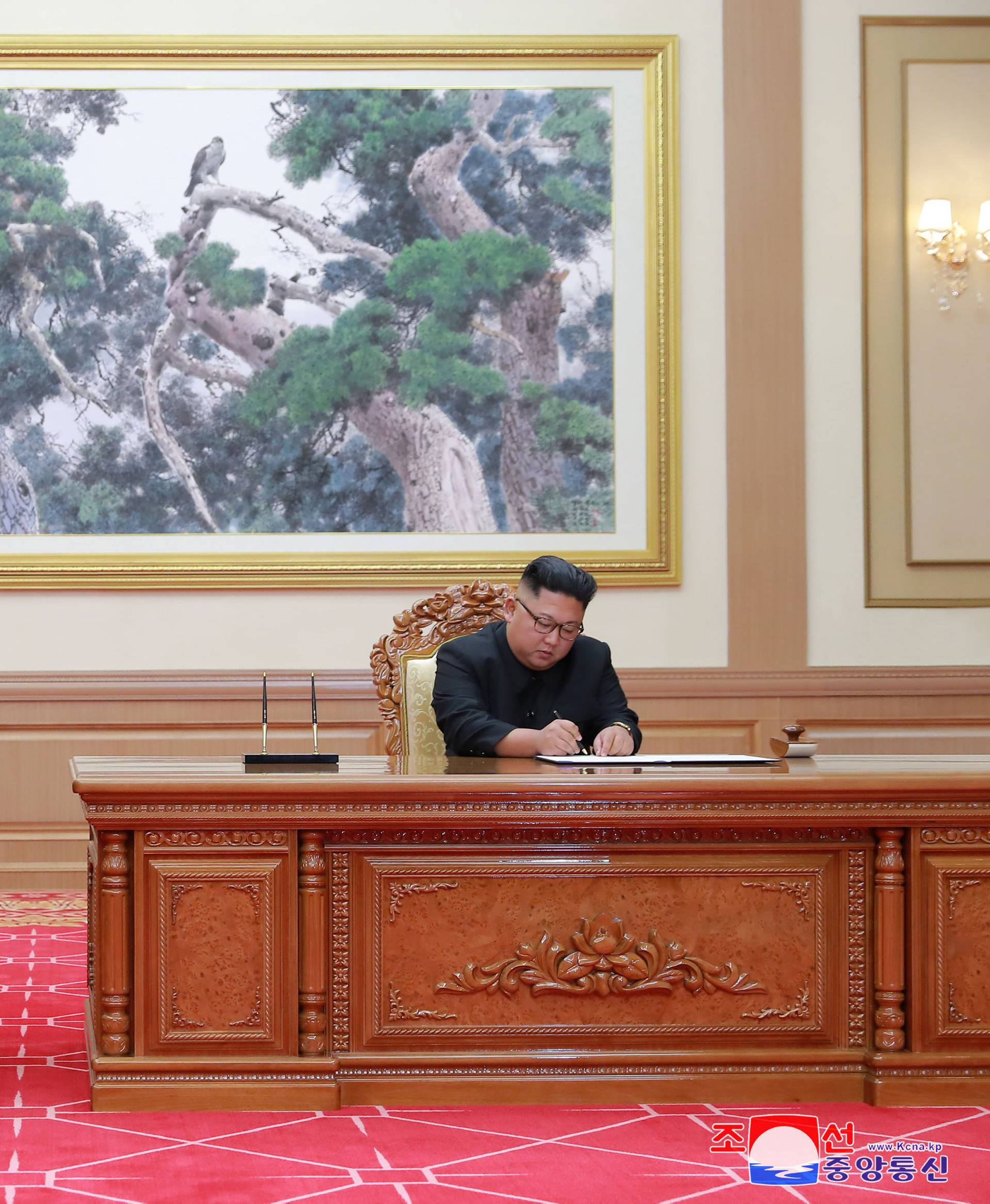South Korean President Moon Jae-in and North Korean leader Kim Jong Un sign a joint statement in Pyongyang in this photo released by North Korea's Korean Central News Agency