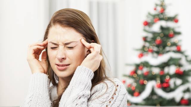 young girl has headache of christmas stress