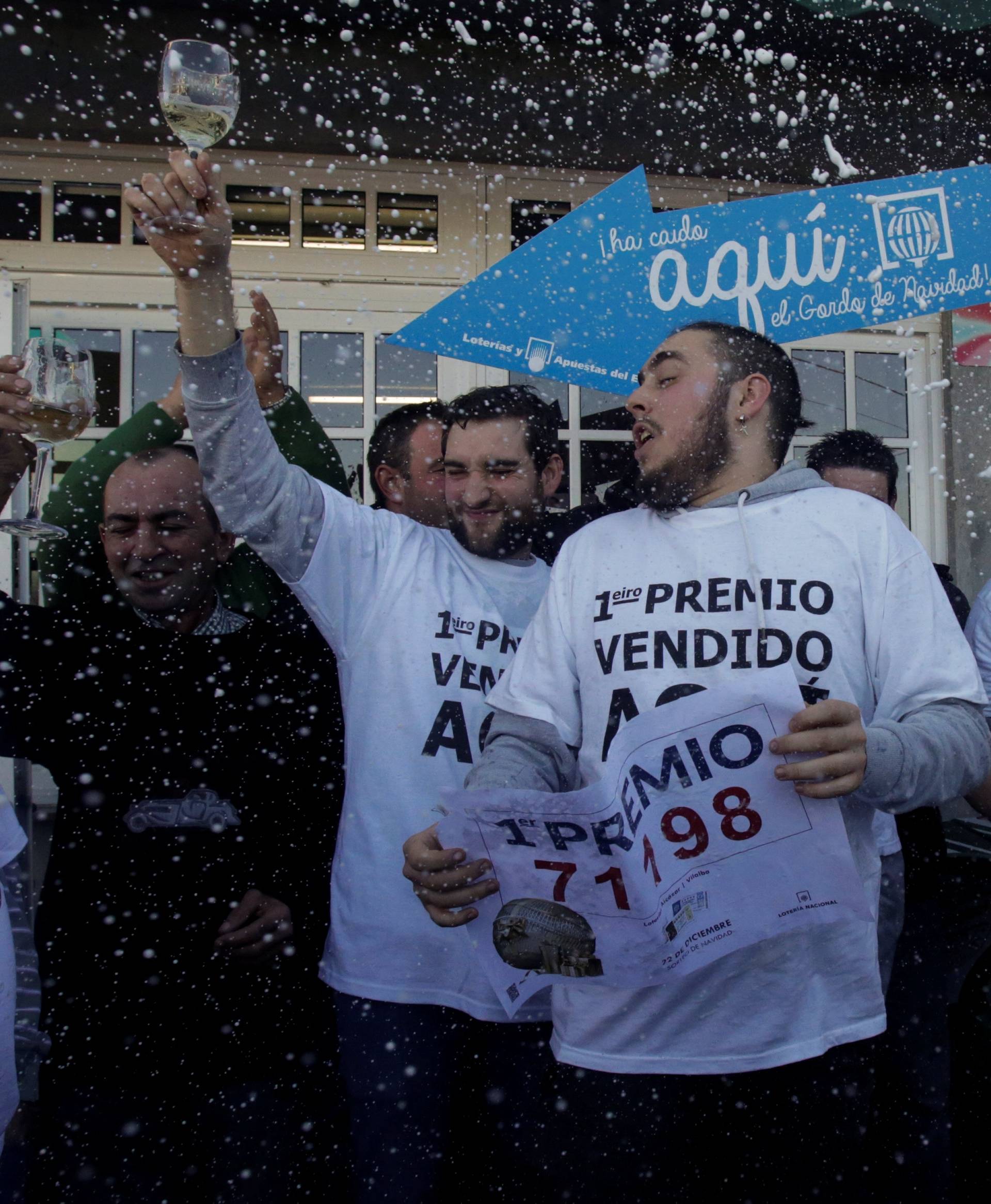 People, who bought winning tickets of the biggest prize of Spain's Christmas Lottery "El Gordo" (The Fat One), celebrate in Vilalba