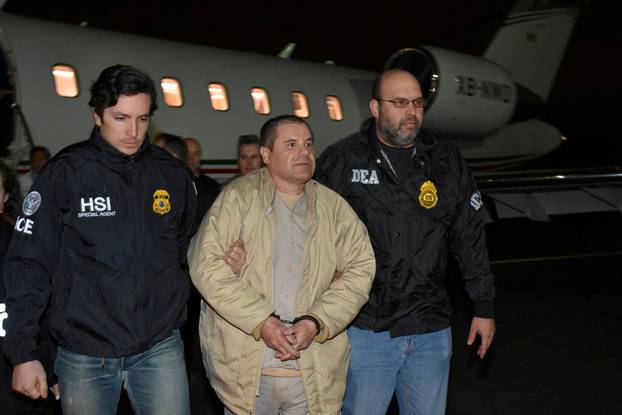 FILE PHOTO: Mexico's top drug lord Joaquin "El Chapo" Guzman is escorted as he arrives at Long Island MacArthur airport in New York