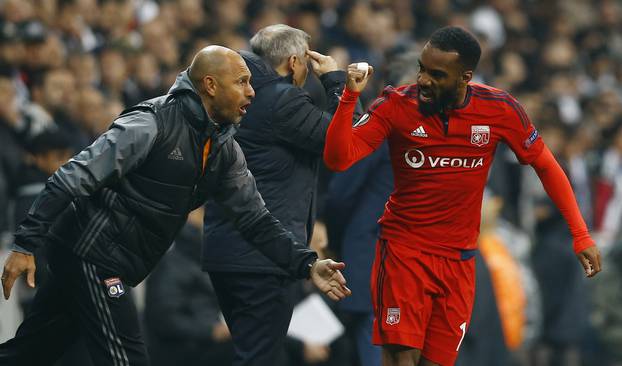 Lyon's Alexandre Lacazette celebrates scoring their first goal as Lyon coach Bruno Genesio (C) looks on