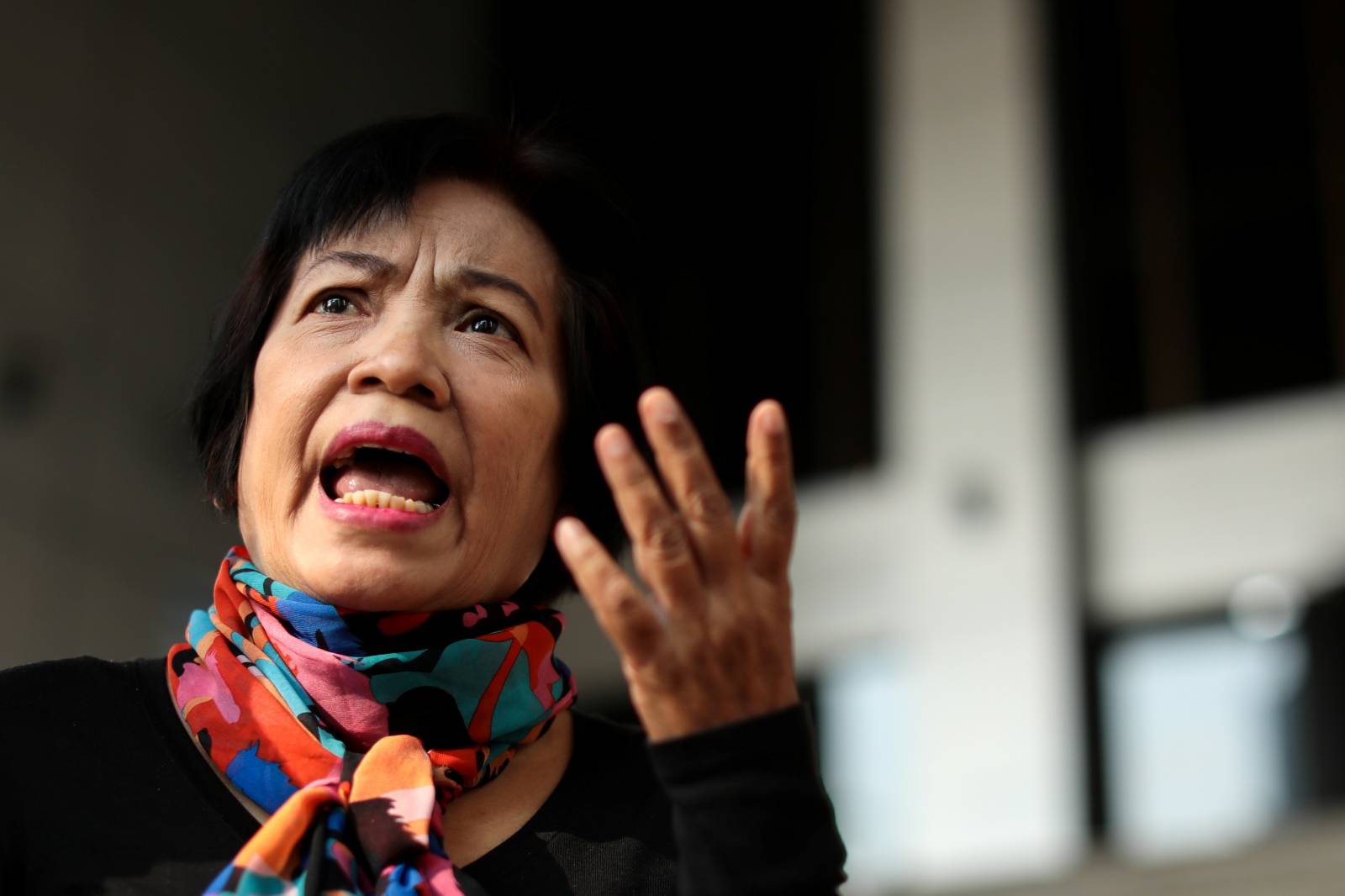 Anchan Preelert talks to media as she arrives to the court before being sentenced to 43 years in jail for sharing online posts criticizing the royal family, in Bangkok